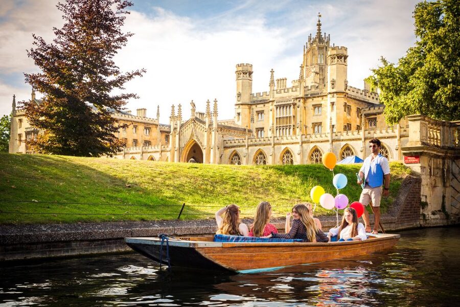 Cambridge: Shared Punting Tour with Guide - Jesus Green Moorings setup: raised seats, tables, blankets, and umbrellas