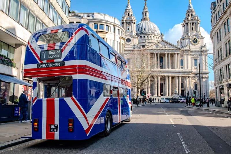 A Union Jack double-decker passing St Paul’s Cathedral in London